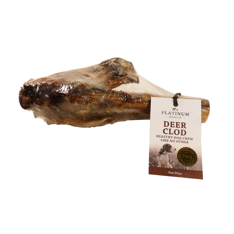 A selection of natural dried treats for pets, including various bones and chews on a bed of hay.